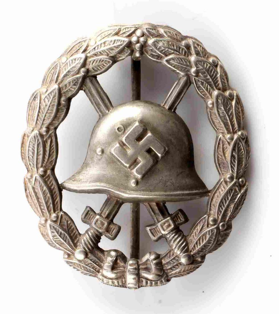 WWII GERMAN THIRD REICH SILVER CONDOR LEGION BADGE: WWII German Condor Legion badge in silver. Cut out type. Measures approximately 1.75 inches in diameter with a 180 degree pin lie. Very good condition overall. This lot has a reserve.
