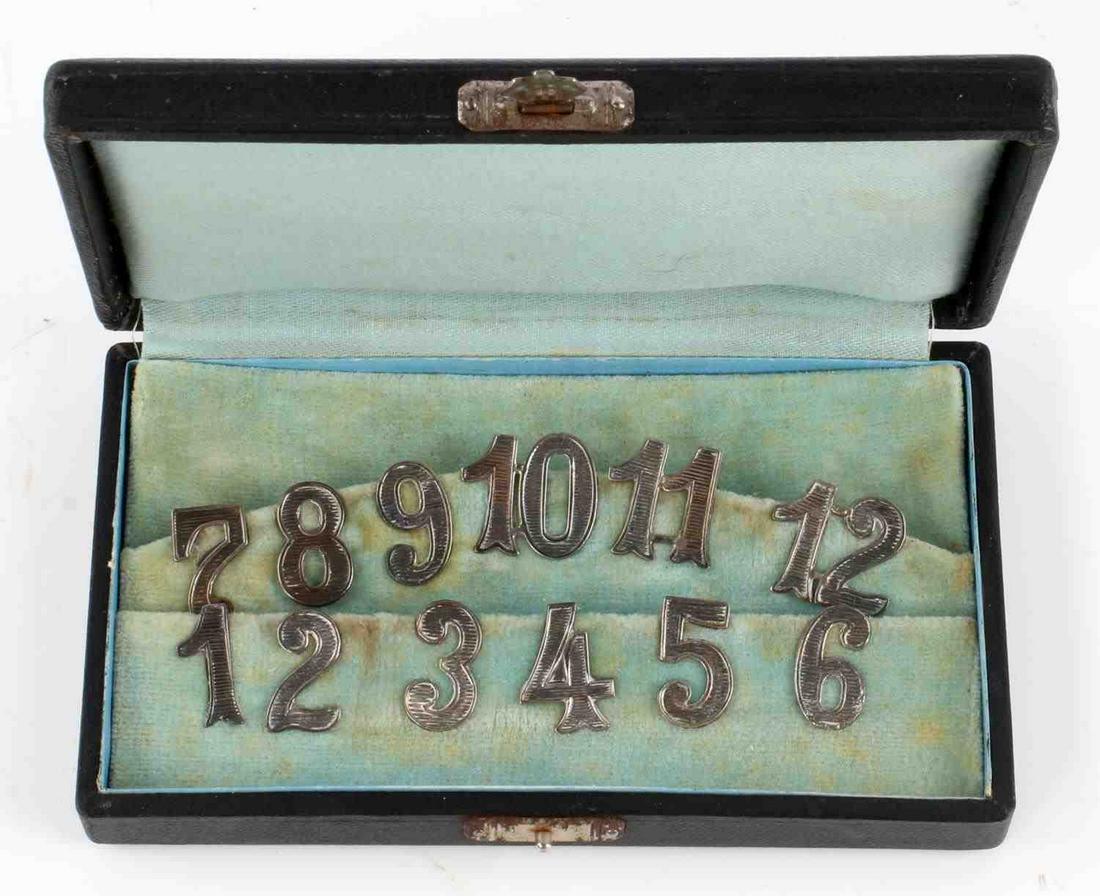 WWII GERMAN 800 SILVER INSIGNIA NUMBER SET 1 TO 12: 800 silver number set 1-12, each piece measures 5/8 inches and is maker marked with 'V' and 800 for silver content. Comes in light blue felt-lined case. Very good condition.