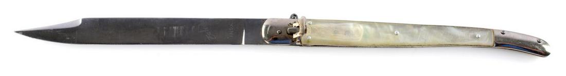 VINTAGE LEVER LOCK SWITCHBLADE PRL MADE IN TOLEDO: 11 3/4 inches overall. 5 1/2 inch blade. Steel spear point blade marked ' Toledo INOX'. Lever lock style. Has pair of mother of pearl handled riveted into place onto nickel body. Very good condition. 