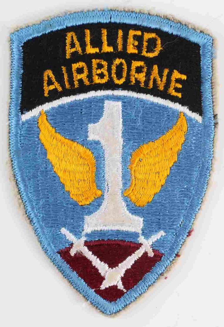WWII US ARMY 1ST ALLIED AIRBORNE SHOULDER PATCH: US WWII Army 1st Allied Airborne Shoulder Patch. Measures 2 5/16” wide by 3 9/16” tall. The front reads ‘Allied Airborne’. There is a winged # ‘1’ in the center with crossed swords at the