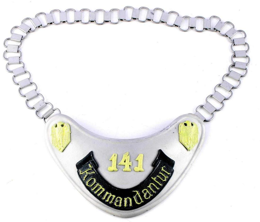 WWII GERMAN THIRD REICH HEER KOMMANDANTUR GORGET: German WWII Army Kommandantur 141 Gorget & Neck Chain. Measures 6 1/2 X 4 1/2 inches. The front reads ‘141 Kommandantur’. It shows an army eagle clutching a swastika in his talons in each corner.