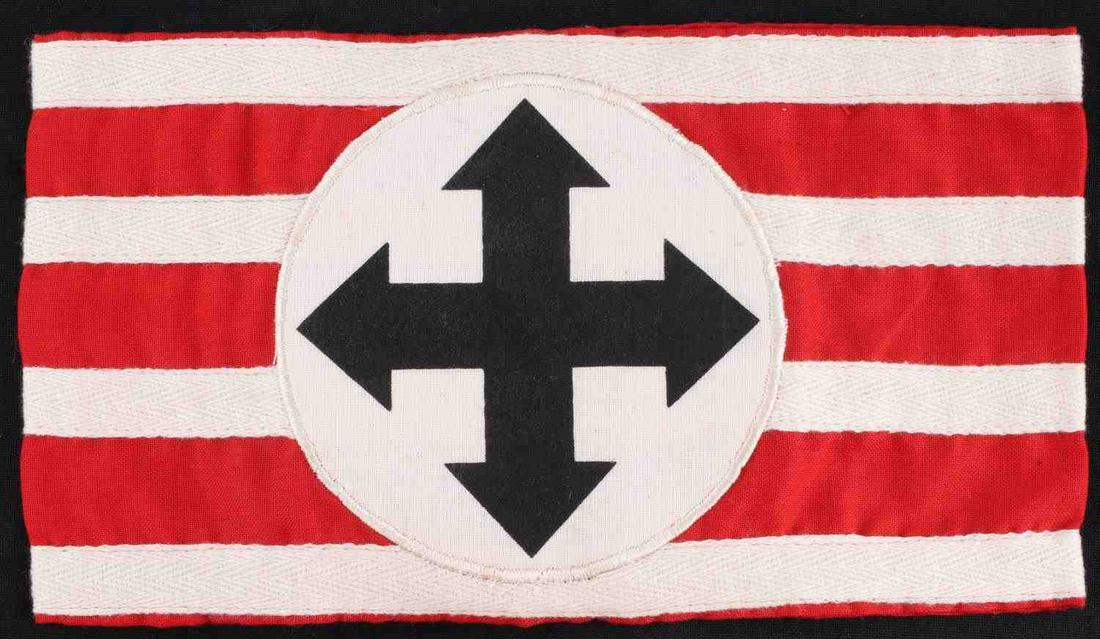 WWII GERMAN WAFFEN SS HUNGARIAN LEADER ARMBAND: German WWII Waffen SS Hungarian High Leader Arm Band. Measures 8 7/8” wide by 4 3/4” tall. The front shows four crossed arrows in the center of a round circle. It is sewn onto a red rectangle arm 