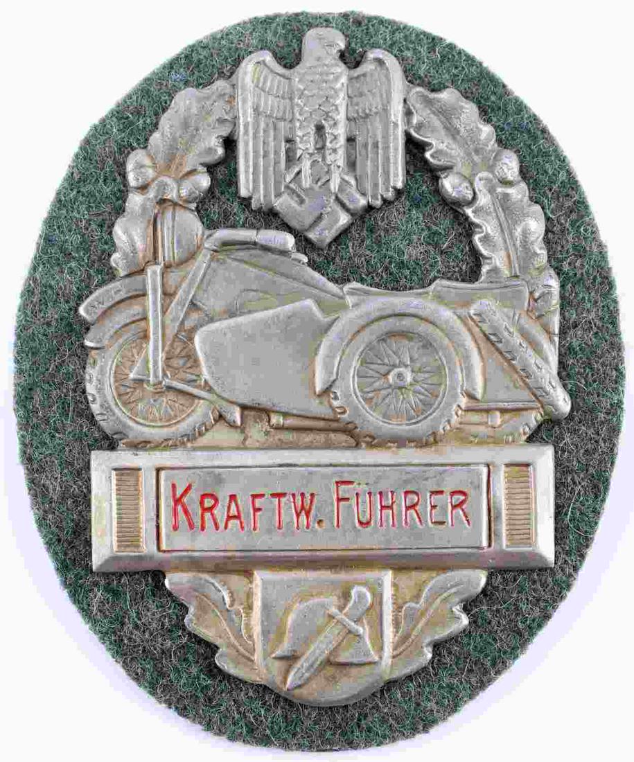 GERMAN WWII ARMY HEER FUHRER MOTORCYCLE BADGE: 2 1/2 X 3 inches. German eagle clutching swastika. Profile of motorcycle with side car and dagger and German helmet. Reads 'Kraftw. Fuhrer.' Everything is surrounded by oval oak leaf wreath. Aluminum 