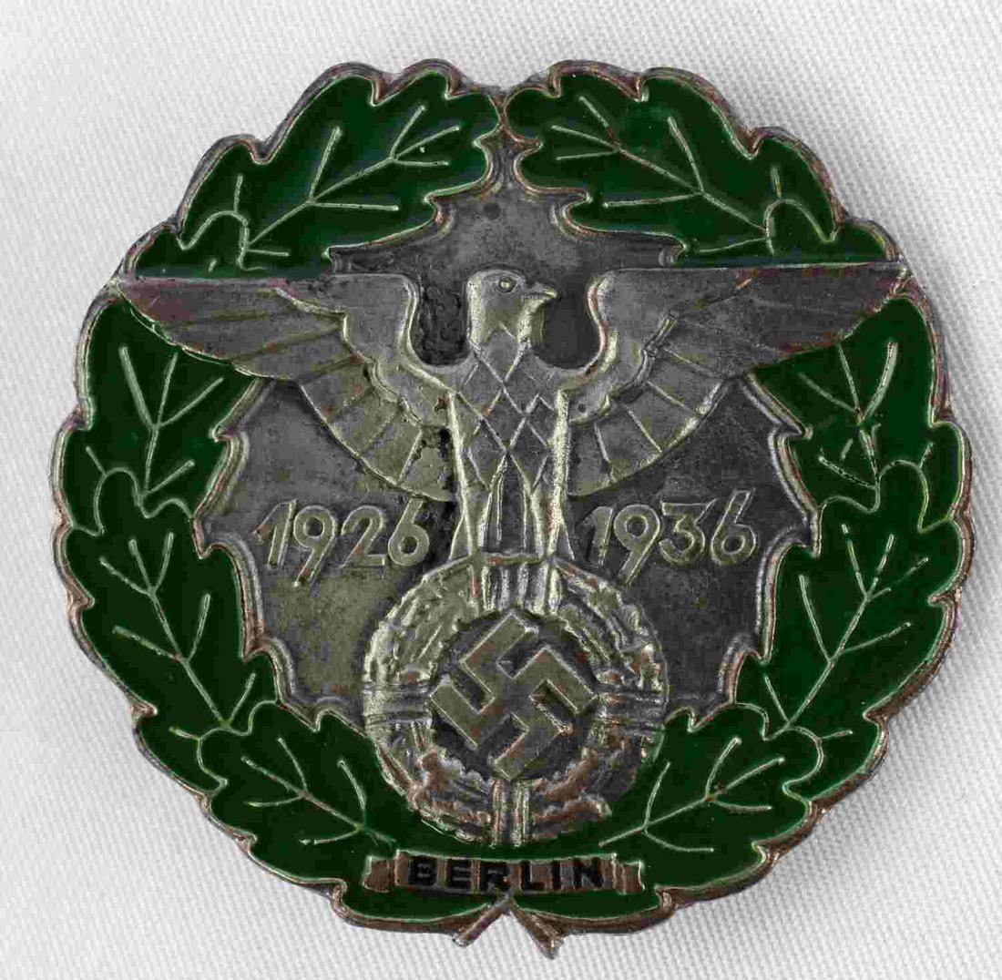 WWII GERMAN THIRD REICH GAU BERLIN BADGE: German WWII 1926 â€“ 1936 Gau Berlin Badge. Measures 1 9/16 inches. The front reads â€˜1926 â€“ 1936 Berlinâ€™. There is a German eagle clutching a swastika in his talons in the cen