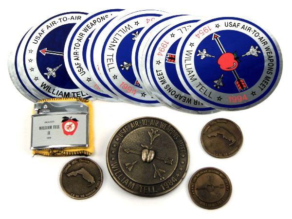 LOT OF USAF WILLIAM TELL MEMORABILIA: Lot of memorabilia from biannual USAF William Tell fighter gunnery competition. Includes decals, brass buckle, 3 commemorative medals, and lighter.