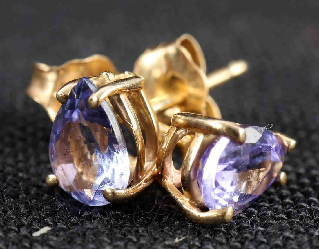PEAR CUT TANZANITE AND 14K YELLOW GOLD EARRINGS: Pear cut Tanzanite and 14k yellow gold stud earrings. Marked 14k on post and backing. Acid tested. Tanzanite is approximately .37ct each earring or .74 tcw.