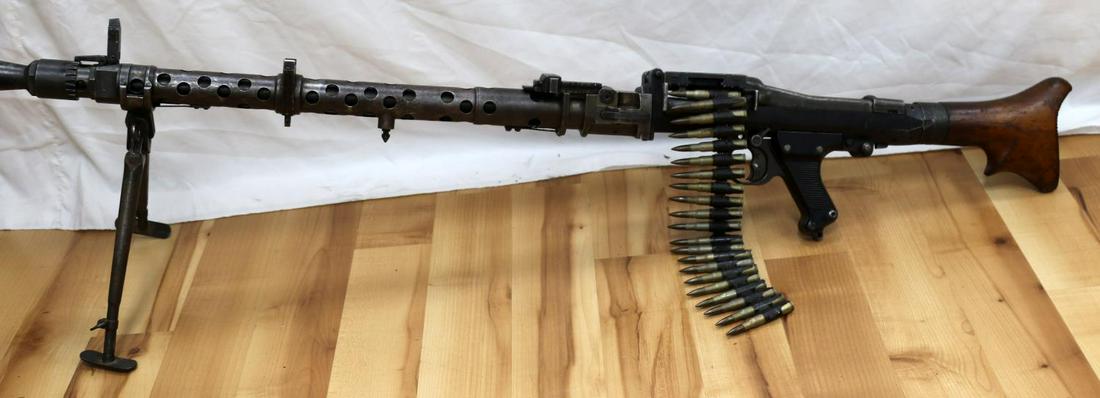 WWII GERMAN DEACTIVATED MASCHINENGEWEHR 34 DISPLAY: WWII German Reich deactivated Maschinengewehr 34 dated 1945 with original functioning bipod. Lower and upper receivers have been completely sealed, the 8mm Mauser casings on the belt that are present 