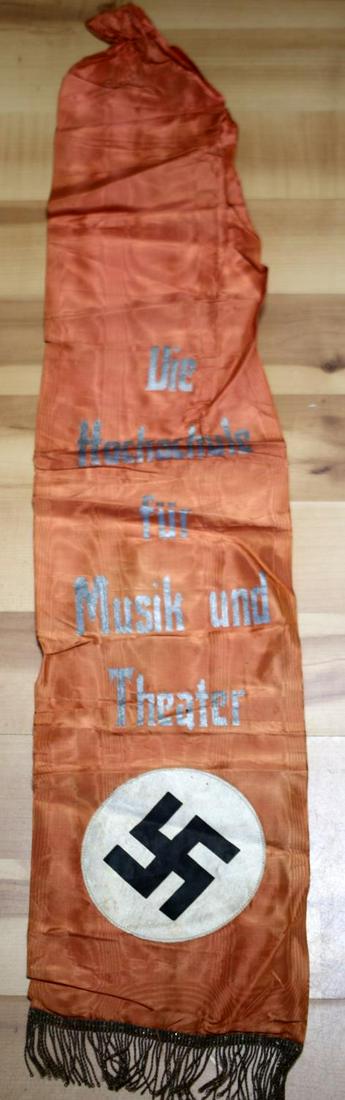 WWII GERMAN REICH MUSIC THEATER UNIVERSITY BANNER: WWII German Third Reich vertical banner measures 40 X 7.75. Flag printing reads "Die Hochschule fur Musik und Theater." Features fringe on bottom, with no printing or markings on back. Significant cre