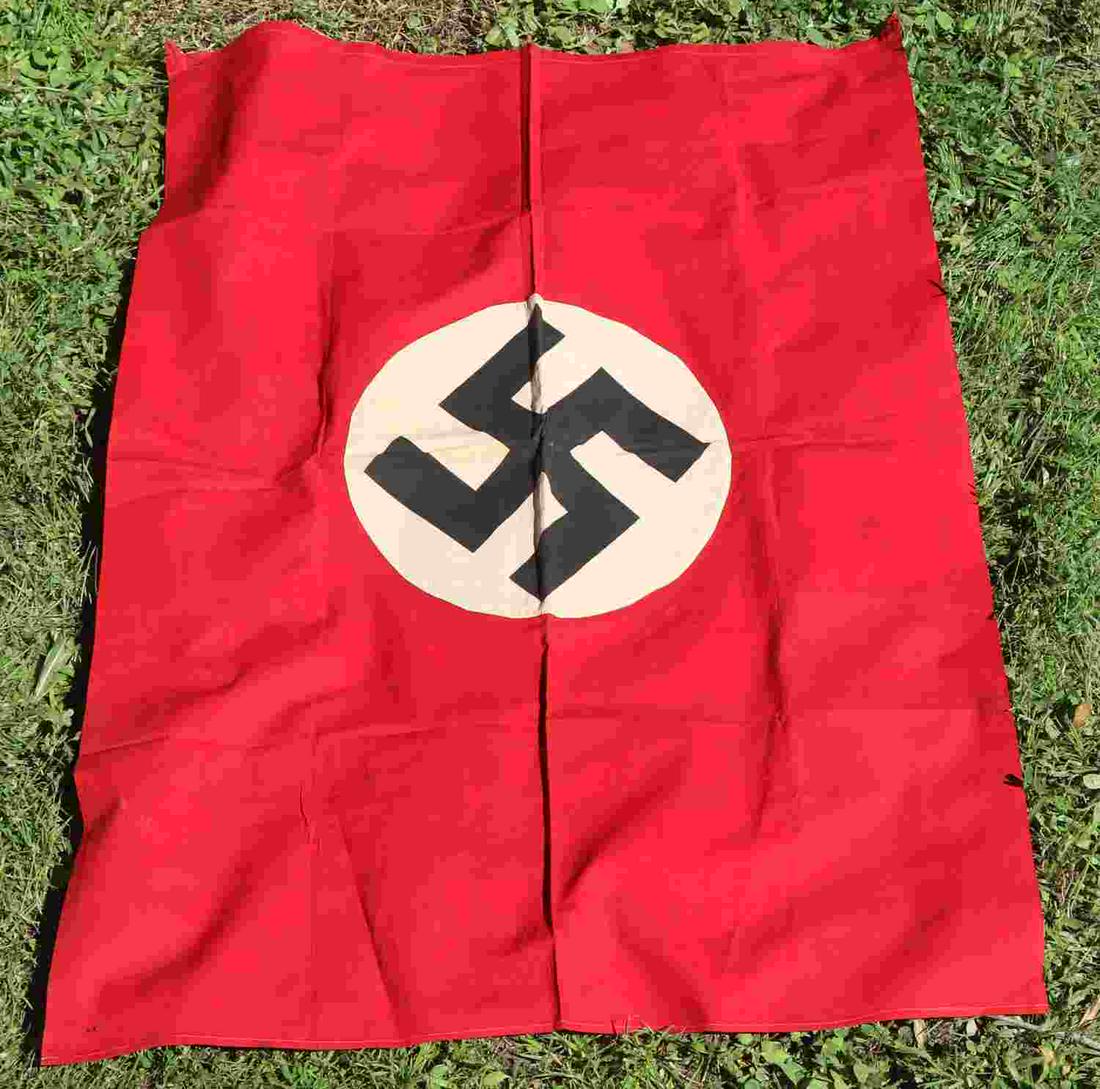 WWII GERMAN THIRD REICH NSDAP VEHICLE ID FLAG: WWII German Third Reich party emblem probable vehicle identification flag, has cloth loops instead of grommets, measures approx. 43 X 29 inches. Minor discoloration in the center of emblem with no maj