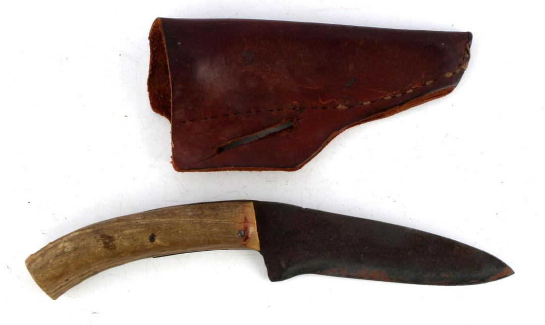 VINTAGE STEEL KNIFE WITH ANTLER GRIP: Unnamed vintage knife with steel blade, antler grip, and leather scabbard. Blade features heavy oxidation and pitting. Antler grip has some age with rust spots from nail. Measures 11 inches.