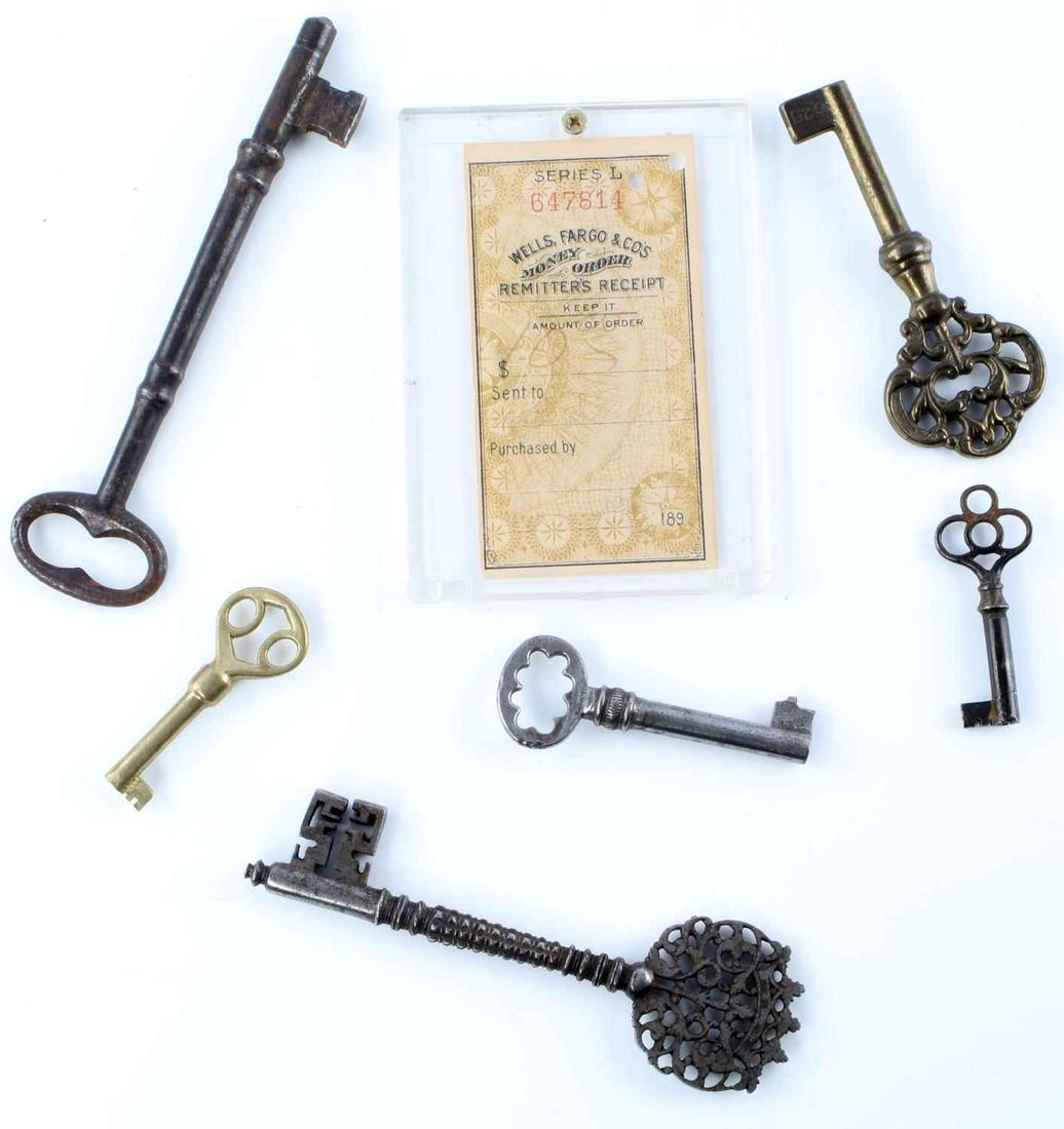 6 ANTIQUE BRASS KEYS WITH WELLS FARGO RECEIPT: Lot of 6 antique brass keys and a Wells Fargo money order remitters receipt. Numbered 647814. Hand written note on reverse reads For 20 acres of land. Paid in full." With a name. Key measurements rang