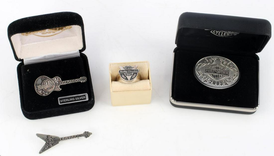HARLEY DAVIDSON & HARD ROCK CAFE STERLING PIN LOT: Lot includes: Harley Davidson 2003 oval medallion in case (1 5/8 inches), Harley Davidson 50th year anniversary sterling ring (size 9.5), and two Hard Rock Cafe Orlando sterling guitar pins (1 7/8 inc