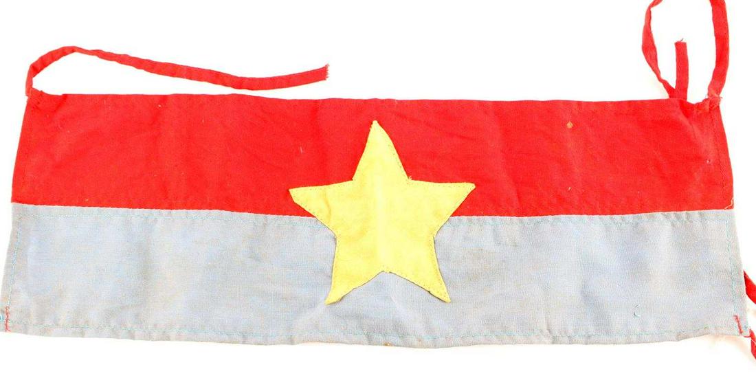 VIETNAM WAR VIET CONG SINGLE STAR ARMBAND: Viet Cong arm band. Features red and blue with single white star in center. Good condition with some staining. Measures 13 1/2 inches