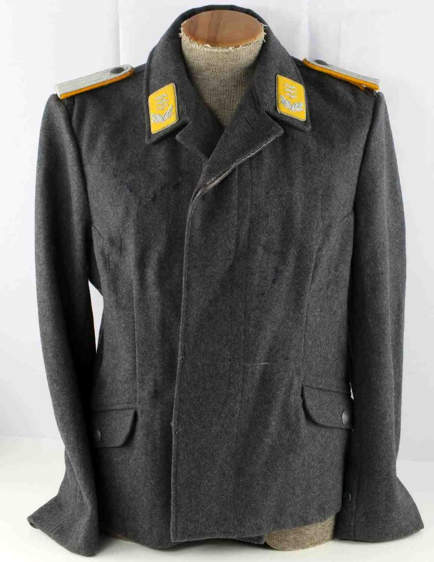 WWII GERMAN LUFTWAFFE CAPTAIN OFFICERS TUNIC: Blue wool tunic, size 40R with Hauptmann shoulder boards and collar tabs. Numbers stamped to inner left pocket. Other insignia removed. Very good condition. Unauthenticated, sold as is.