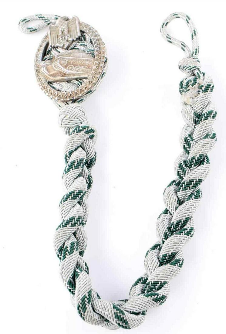 WWII GERMAN THIRD REICH PANZER SHOOTING LANYARD: Third Reich Panzer shooting lanyard with badge. Silver and green bullion braid with badge at top. Measures 15 1/2 inches. Fluoresces. Good condition. Unauthenticated, sold as is.