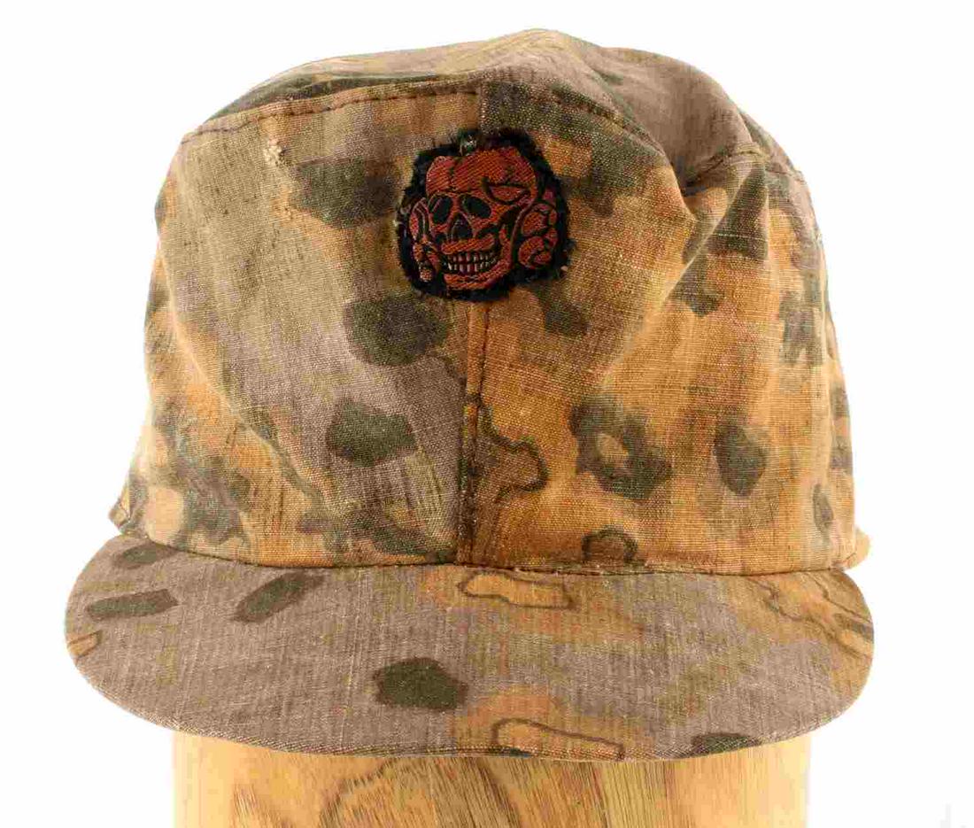 WWII GERMAN WAFFEN SS CAMOFLAGE FIELD CAP: WWII German Waffen SS camoflage field cap. Autumn camoflage design featuring a Totenkopf patch to the front. Fading to the colors present. Unmarked and untagged. Overall good condition.