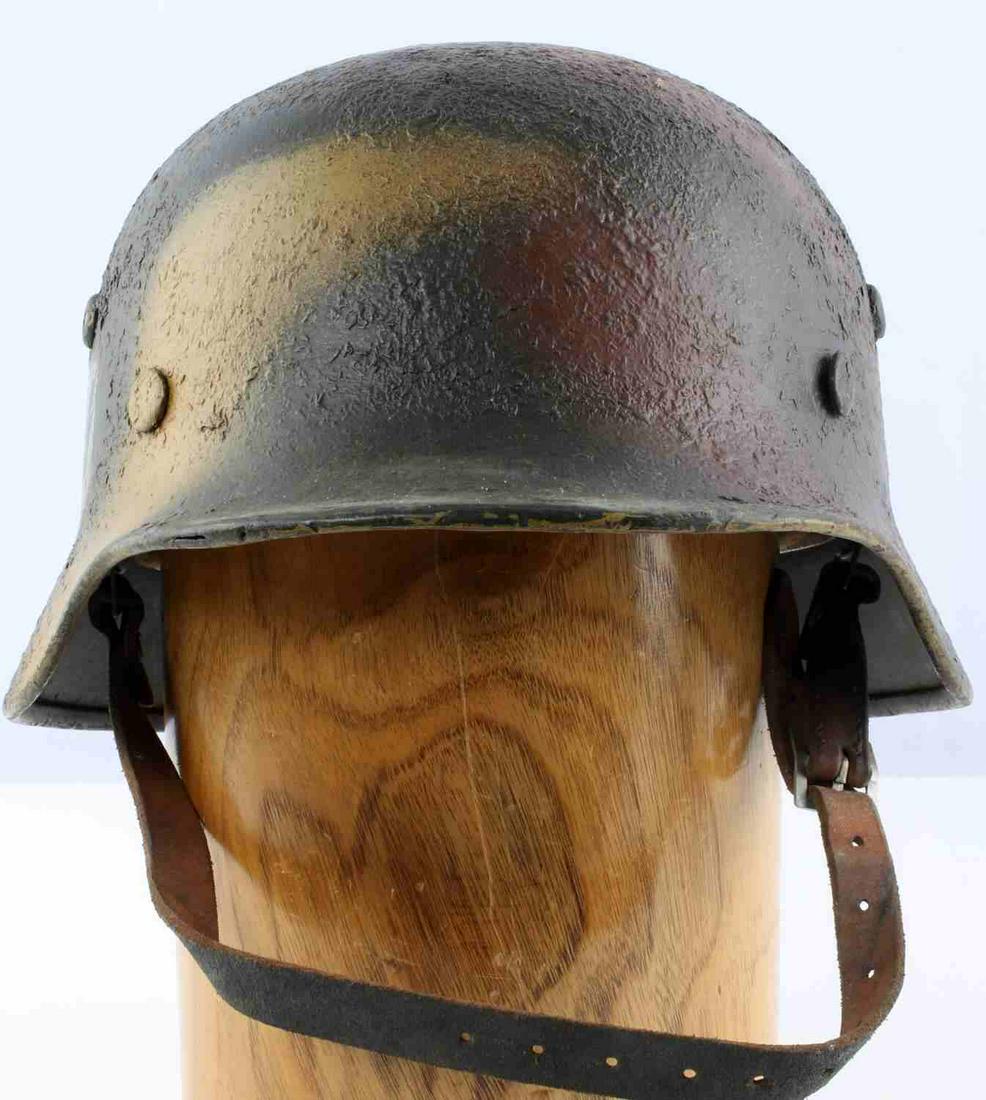 WWII GERMAN THIRD REICH SS CAMO M38 HELMET: WWII German Third Reich SS camo M40 helmet. Single rivet and vent on either side and rivet on back. SS decal on right side. Metal liner with head band 8 finger leather liner. Leather chin strap is int