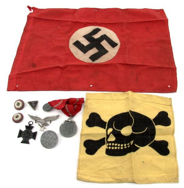 MIXED LOT OF THIRD REICH FLAGS MEDALS AND PINS: WWII German lot includes: yellow flag with black cross bones and skull poison flag (7.5 x 7.5 in.), Third Reich Nazi cloth party flag (11 x 15 in.), "1914-1918" Non-Combatant's Hindenburg Cross (given