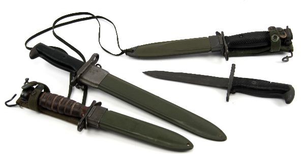 LOT OF FOUR US BAYONETS; M7 M4 CAMILLUS & MORE: Grouping of four US bayonets. A US M-7 bayonet with M8A scabbard for use with M-16 rifle. A Camillus M-4 bayonet with leather grip. 8A1 scabbard for use with US M-1 Carbine. An M-1 Garand bayonet with