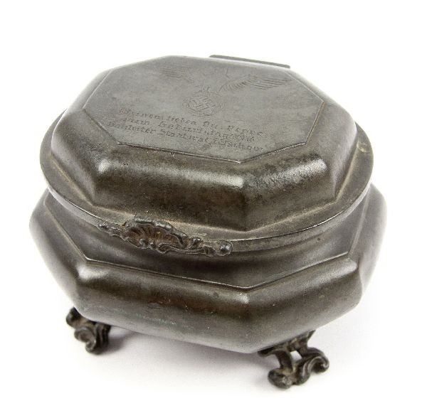 WWII GERMAN NAZI PRESENTATION TABACCO HUMIDOR: 5x5x4 inch footed pewter tobacco humidor engraved with Nazi Nuremberg party eagle and inscribed "To my dear party member Zum Geburistag from Gaulieter Staadtsrat Telschow" in German. Very good conditi