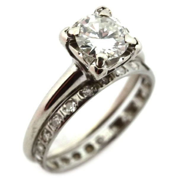LADIES 14K WHITE GOLD DIAMOND WEDDING SET: Diamond solitaire engagement ring with a 1.11ct round brilliant diamond of J color and I1 clarity, set in a four prong illusion head. Wedding band with (21) round cut flush set diamonds totaling appro