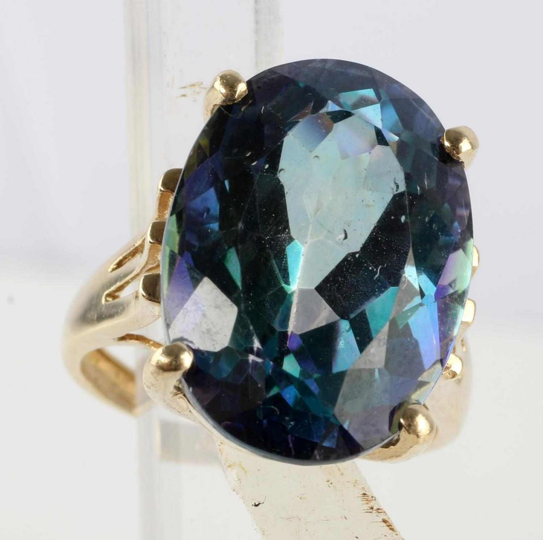 17.5 CARAT MYSTIC TOPAZ 14K YELLOW GOLD RING: Oval faceted mystic topaz solitaire four prong set yellow gold vintage ring. Size 7.5 cocktail ring. In very good condition, marked "14K' inside shank. Ring weighs 6.9 grams total. Gold has been acid 