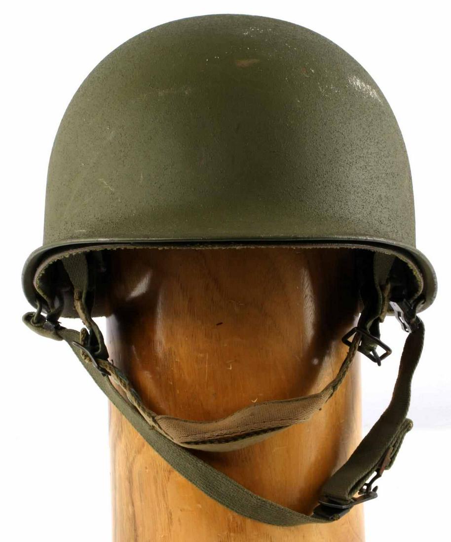 U.S. PARATROOPER VIETNAM M1C HELMET W SWIVEL BALES: U.S. Paratrooper Vietnam M1C Helmet with Swivel Bales. Has complete exterior and interior shells. Exterior shell has rear center seam, swivel bales, full chinstrap and is marked "0553" on lower interi