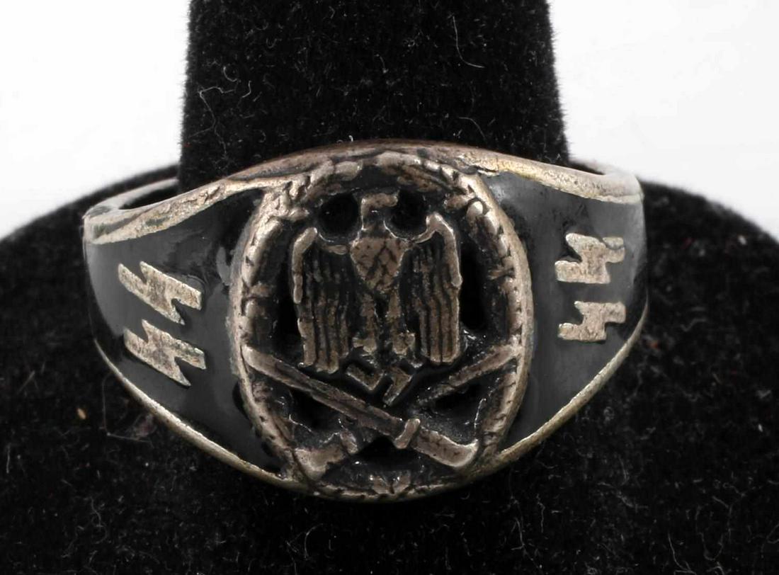 WWII GERMAN WAFFEN SS 900 SILVER RING: WWII German Waffen SS ring marked 900 silver. Tests for silver. Size 11. Face features a Reichsadler with a rifle and bayonet crossed below all surrounded by an oak leaf wreath. Black enamel to each s