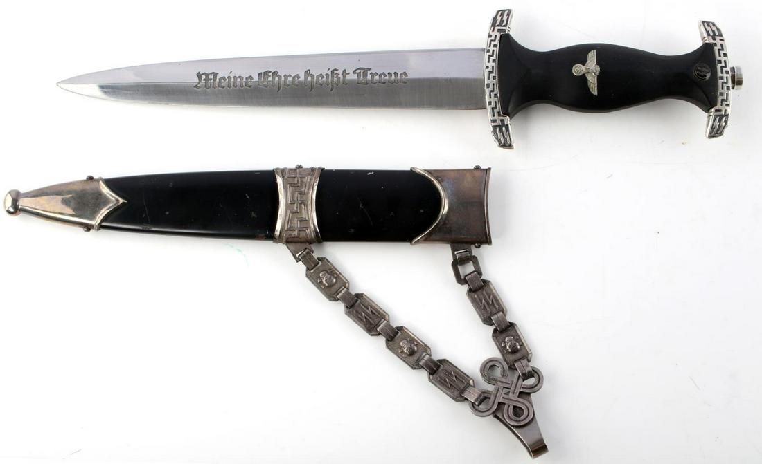 WWII GERMAN WAFFEN SS OFFICER PRESENTATION DAGGER: WWII German Waffen SS Officer presentation dagger with scabbard and chain. Black ebony wood handle with nickel pommel and crossguard. Pommel and crossguard designed with swastikas and SS runes to the 