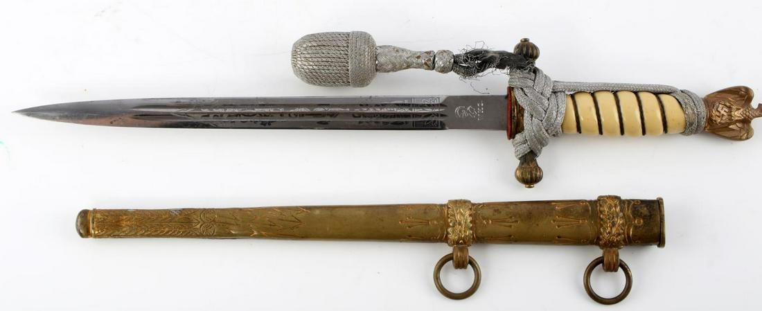 WWII GERMAN KREIGSMARINE OFFICER DAGGER W SCABBARD: WWII German Kreigsmarine officer's dagger with scabbard. Bakelite off-white grip with nickel pommel and crossguard. Reichsadler to pommel and naval insignia to the crossguard. Nicely double-etched bla