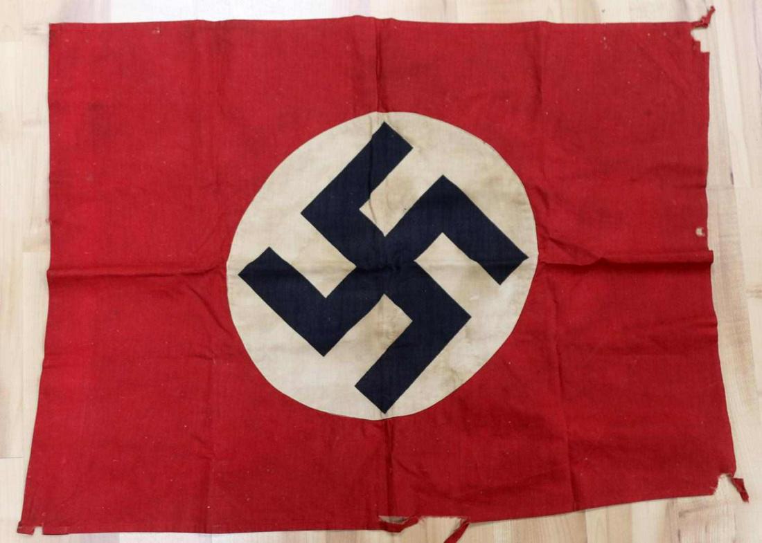 WWII GERMAN THIRD REICH NSDAP EMBLEM FLAG: WWII German Third Reich NSDAP Emblem Flag, measures approx. 18 x 22 inches. Multi-piece, double sided display with a single hoist. Mild to moderate discoloration to emblem and tearing to outer edges. 