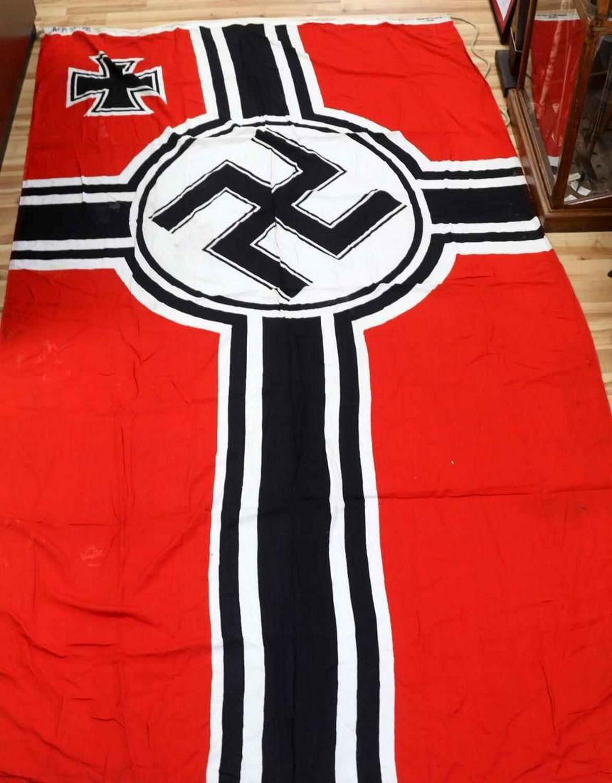 WWII GERMAN THIRD REICH KRIEGSMARINE BATTLE FLAG: WWII German Reich Kriegsmarine battle flag. National colors of red, white, and black. Large printed party symbol in the center with stripes. Measures 127 X 70 inches. Hoist marked Kr. Fl. 200 X 335 Fe