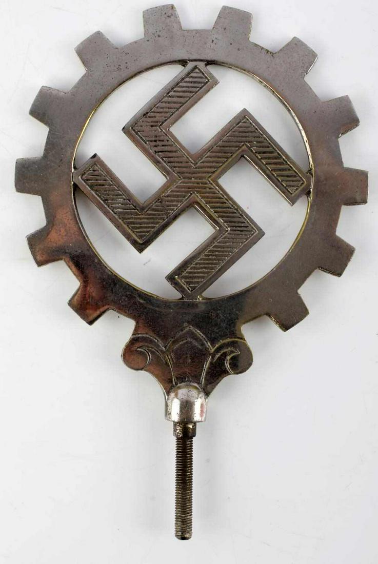 WWII GERMAN THIRD REICH DAF FLAG FINIAL: WWII German DAF (Deutsche Arbeitsfront) flag finial. Features ribbed swastika to center of a gear. Overall very good condition. 8 1/4 X 5 1/2 inches.