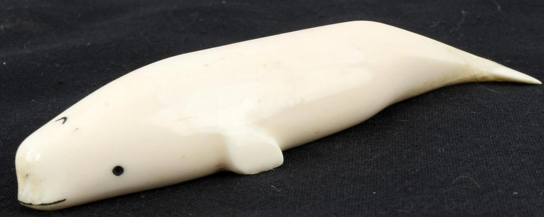 VINTAGE INUIT CARVED BONE NARWHAL WHALE FIGURE: Narwhal carved out of bone, measuring 5 x 1 inches. Not signed. Missing original nose / tusk piece, but otherwise in good condition. Miniscule chip to back dorsal fin.
