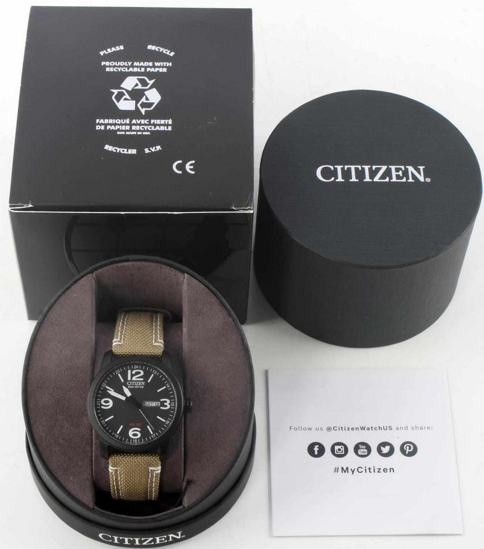 CITIZEN ECO-DRIVE DAY DATE CANVAS BAND BLACK CASE: Men's Citizen Eco-Drive quarts watch. Hunter green canvas band and black plasti-dip case. Face is Arabic stick and has a day and date complication. Case is 42 millimeter and has 3 hand movement. Lot i