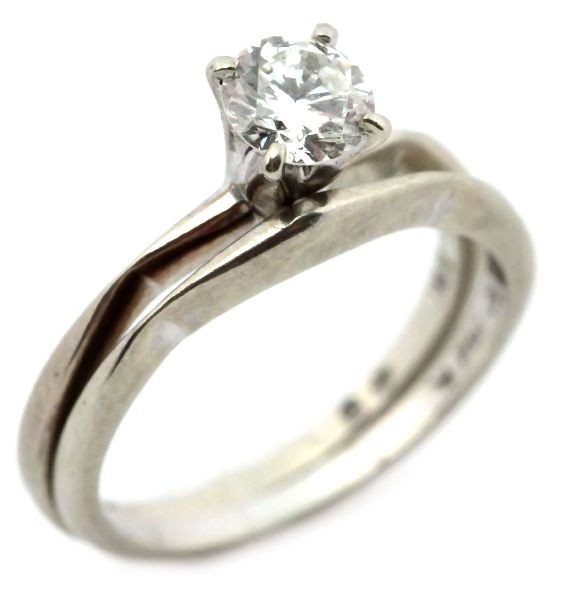 LADIES 14K WHITE GOLD 0.6CT DIAMOND WEDDING SET: Approximately 0.6ct round cut diamond solitaire in a four prong setting. . Size: 5 . Weight: 3 g . Condition: Very good