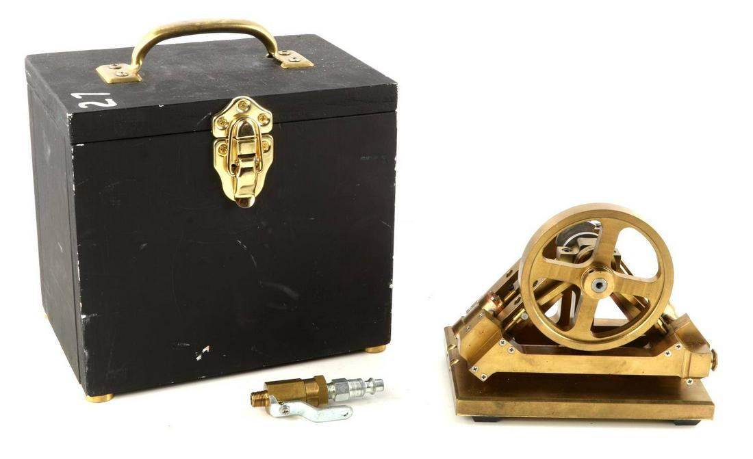 MINIATURE HAND BUILT BRASS STEAM ENGINE MODEL: Miniature hand built brass steam engine. Mostly solid brass. Large flywheel with 2 pistons. Wheel spins and turns the pistons. Bottom is named Roy Foote. Likely the previous owner. Comes with case. Me