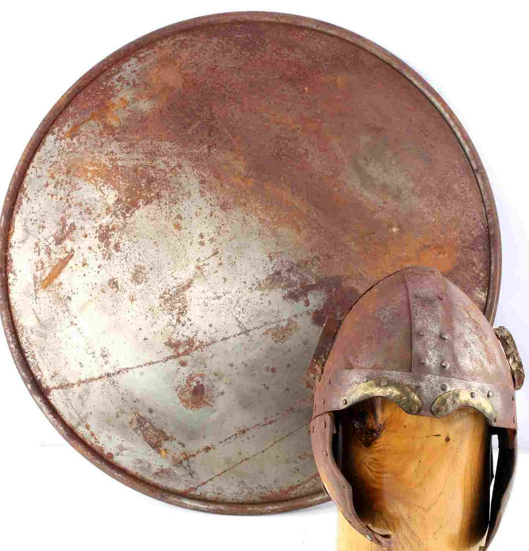 LOT OF 2 FANTASY ANCIENT VIKING HELMET AND SHIELD: Lot features a Scandinavian Viking style helmet and shield. Helmet is missing horns and heavily oxidated. Shield is also heavily oxidated and measures 23 inches.