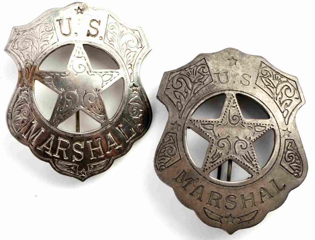PAIR OF OLD WEST US MARSHALL BADGES: Convex shield shaped badge with tooled scrolling, leaf and star motif. One badge features C clasp. Both measure 2 3/4 x 2 1/8 inches. Homage badges.