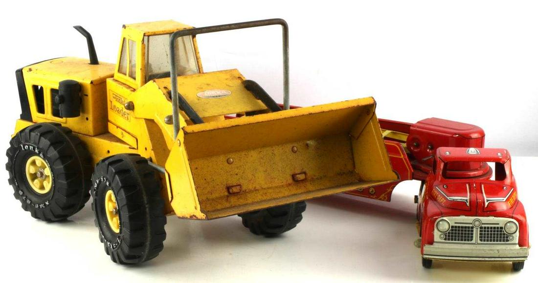 TONKA LOADER TRUCK & HOOK & LADDER FIRE TRUCK 70'S: Front end loader Tonka truck, 21 inches long and 9.5 inches tall, and a Hook and Ladder 2-pc fire truck, 23 inches. Good vintage condition.