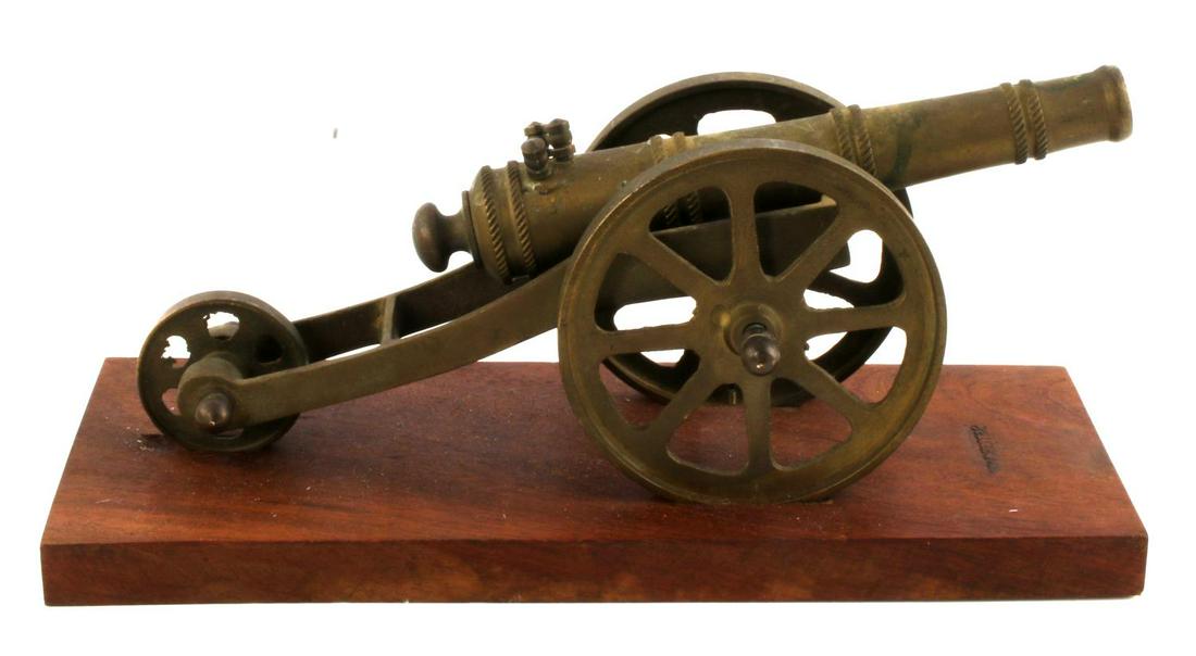 MID CENTURY MINATURE 3 WHEEL SIGNAL CANNON: 11 x 5 x 4 inch miniature brass Signal Cannon mounted on wood base with Winchester pyrogenic branded stamp. In good condition with age patina.