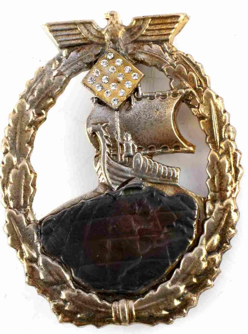 WWI IMPERIAL GERMAN AUXILIARY BADGE WITH DIAMONDS: WWI Imperial German Auxiliary Cruiser badge with simulated diamonds. Features Reichsadler clutching diamond square .Vertical pin with C catch. Measures 2 1/4 inches. Very good condition. Unauthenticat