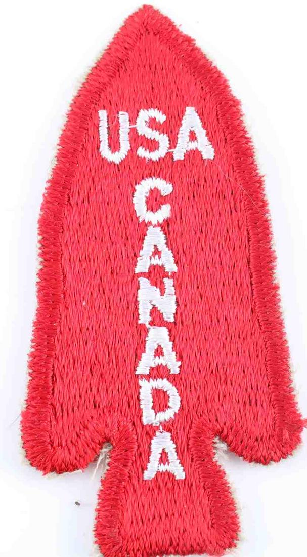 US WWII ARMY FIRST SPECIAL SERVICE CANADA PATCH: Measures 1 1/2 X 3 inches. Front of the arrow head reads "USA CANADA". Machine embroidered on a red cotton background. General Robert T. Frederick was in command of this elite division of combat soldi