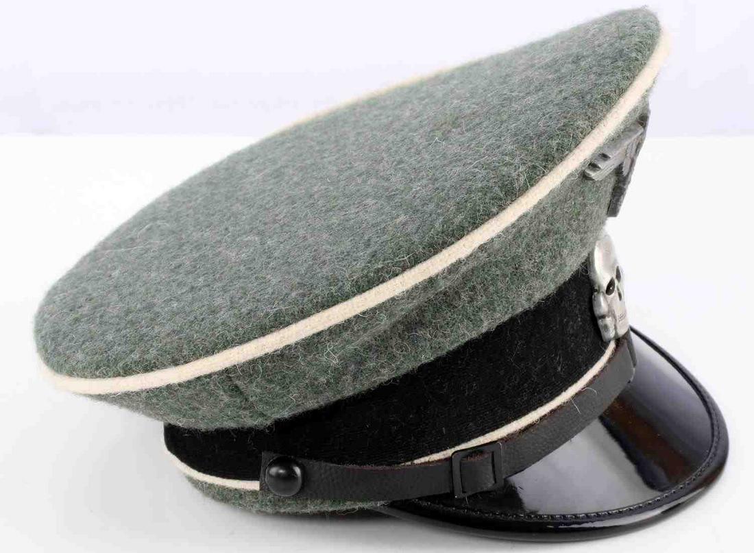 WWII GERMAN THIRD REICH SS SALESMAN VISOR HAT CAP: A small Third Reich SS visor cap for a salesman or child. Wool visor with white piping. Totenkopf and Parteiadler pins. Size 38. Very good condition. Unauthenticated, sold as is. This lot has a reserv