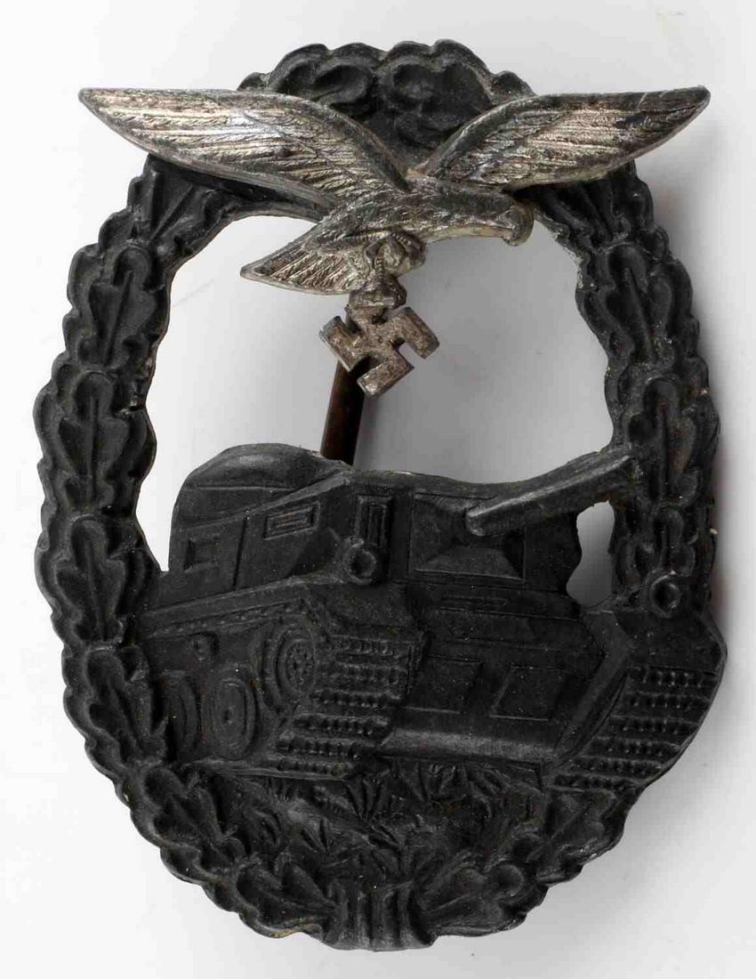 WWII GERMAN THIRD REICH LUFTWAFFE PANZER BADGE: German Luftwaffe Panzer Assault badge. Tank in the center with Luftwaffe Reichsadler at the top surrounded by oak leaf wreath on obverse. Reverse is marked "LA". Has a thin vertical pin back with a "C