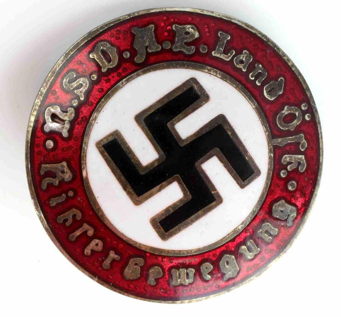 WWII GERMAN HUNGARIAN NSDAP MEMBERSHIP BADGE: WWII German Hungarian NSDAP Membership badge, measuring approx. 1 inch in diameter. Reverse is marked "GES GESCH B," with a thin horizontal safety pin back. One piece vaulted nickel construction with 