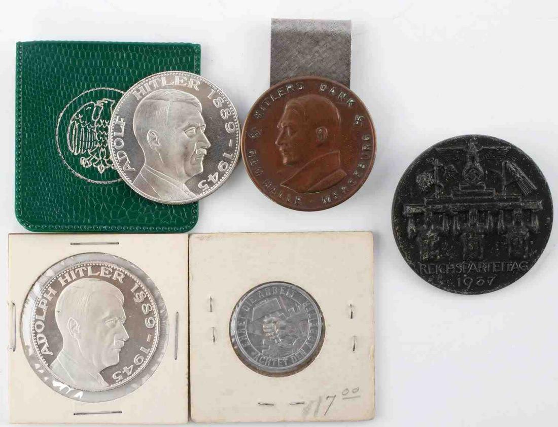 WWII GERMAN REICH LOT OF HITLER COINS & PINS: WWII German Reich lot of Hitler tinnies, pins, and tokens in good condition. To include a "HItlers Dank Gau Halle" pin medal modified with a belt clip on the reverse, two Adolf HItler "Ein Reich, Ein