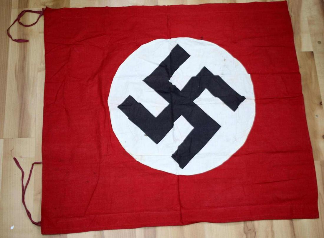 WWII GERMAN THIRD REICH PODIUM BANNER FLAG: Third Reich podium banner flag. Features national colors with party symbol. Measures 31 X 28 1/2 inches. Non-fluorescing. Very good condition with discoloration.