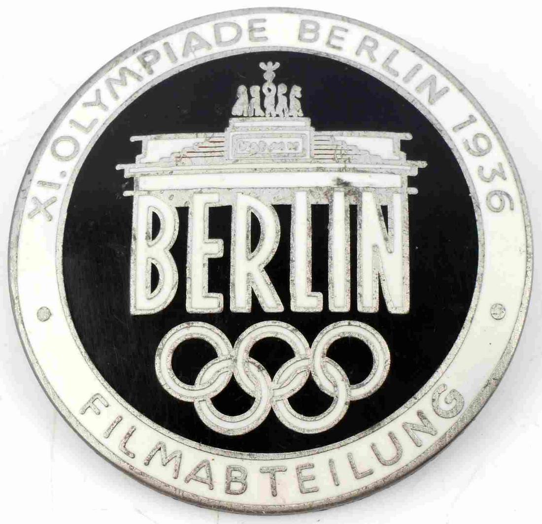 WWII GERMAN THRID REICH OLYMPIC MOVIEMAKER BADGE: Measures 1.5 inches in diameter. Marked Rob Neff Berlin 57 on the reverse. XI. Olympiade Berlin 1936 Filmabteilung on the front. Unauthenticated, sold as is. This lot has a reserve.
