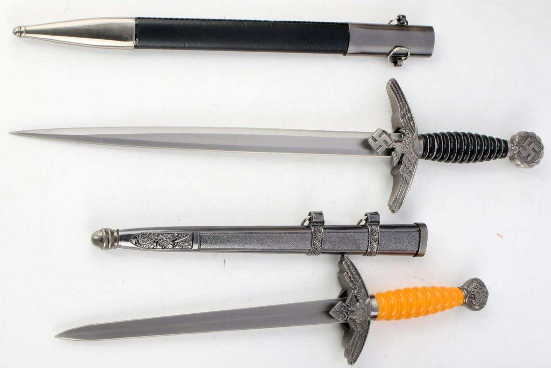 LOT 2 POST WWII GERMAN 3RD REICH LUFTWAFFE DAGGERS: The dagger with the orange handle has a blade that measures 9 inches, the black handled dagger has a blade that measures 12 inches. Both unmarked post WWII productions. Unauthenticated, sold as is. Th